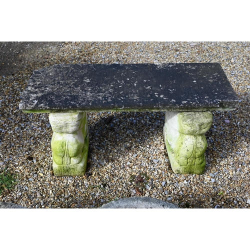 68 - A small weathered three piece cast stone garden bench, with lion form bases