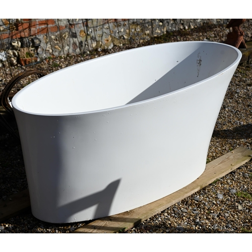 76 - A contemporary reclaimed oval slipper bath c/with chromed pillar mixer taps and shower cradle fittin... 