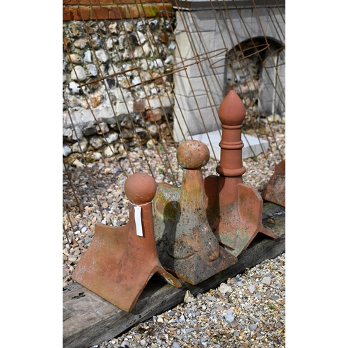 86 - A trio of differing old weathered Bridgwater terracotta ball finial ridge tiles, a/f (3)