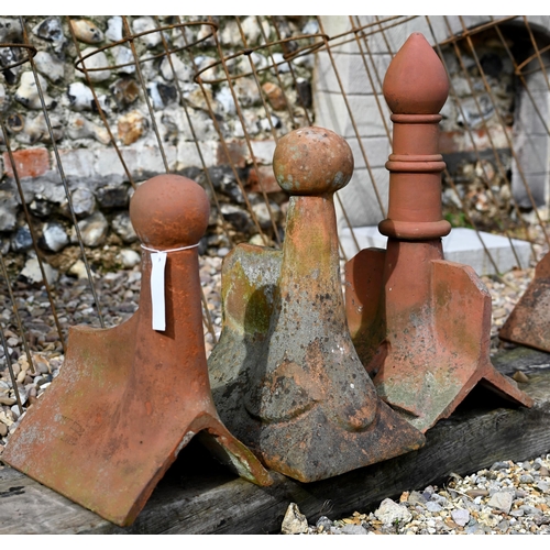 86 - A trio of differing old weathered Bridgwater terracotta ball finial ridge tiles, a/f (3)