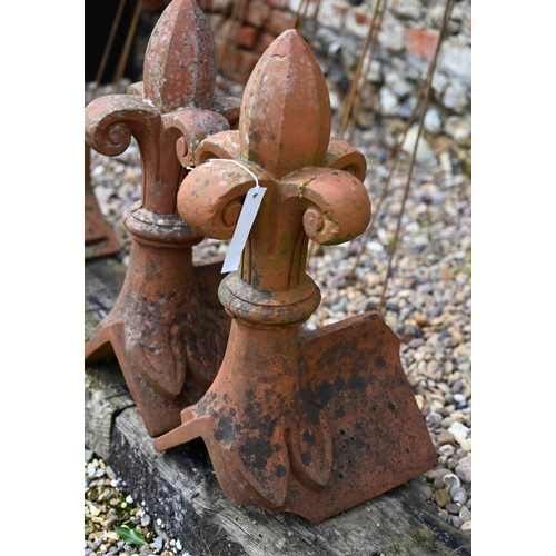 87 - A close pair of old weathered fleur-de-lys finial terracotta ridge tiles, a/f (2)