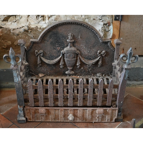 97 - Two old cast iron fire backs to/with three fire baskets, a large cast iron trivet and a pair of fire... 