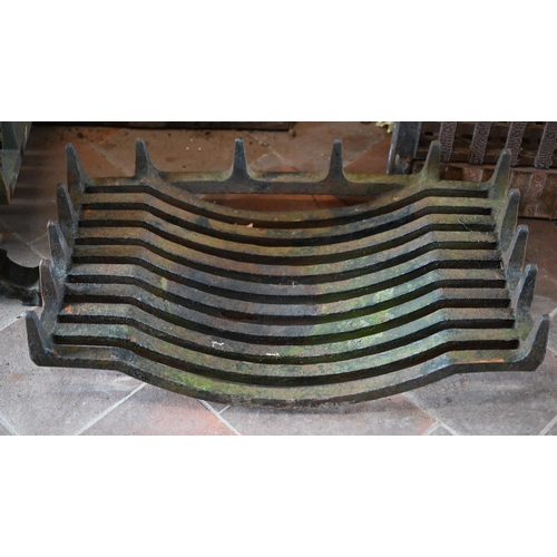 97 - Two old cast iron fire backs to/with three fire baskets, a large cast iron trivet and a pair of fire... 