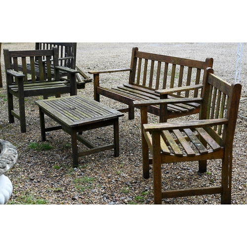 99 - A weathered teak garden bench to/with a pair of arm chairs and a coffee table (5)