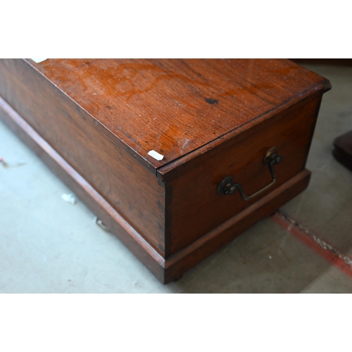 286 - An antique low hardwood brass handled trunk on casters, 112 cm wide x 37 cm deep x 30 cm high