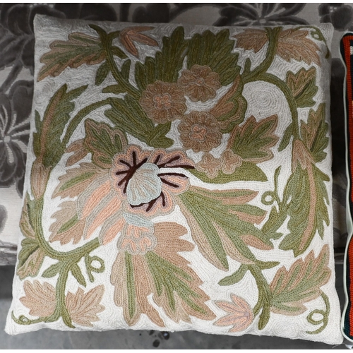 387 - # A floral crewel work cushion and pictorial tapestry cushion, both 40 cm square (2)