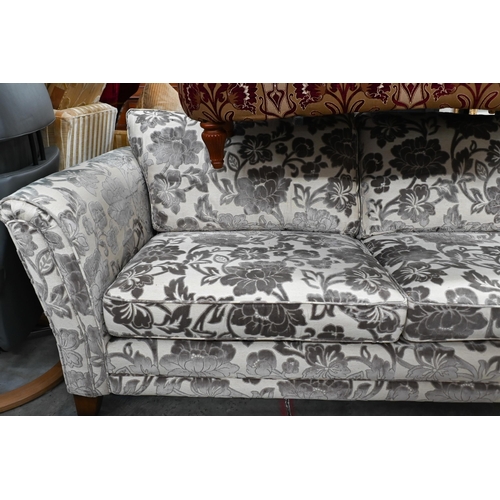 388 - A modern three-seated sofa, the two tone silvered damask style upholstery on square stained hardwood... 