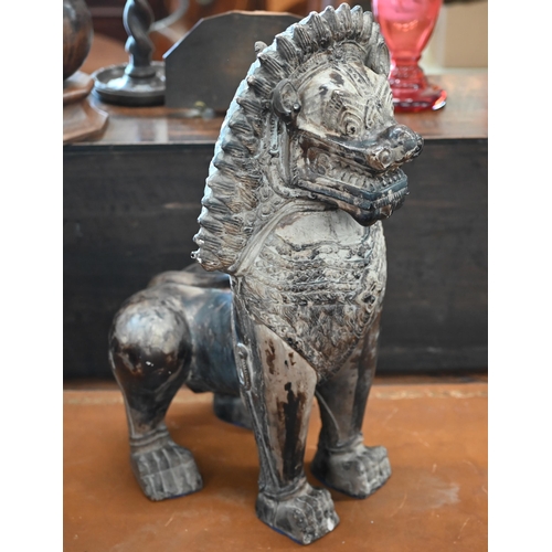 559 - An Asian bronzed ceramic temple lion, 53cm high