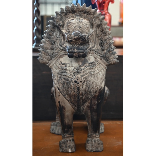 559 - An Asian bronzed ceramic temple lion, 53cm high