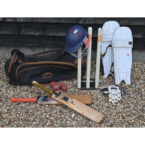 566 - A cricket bag and contents, including two bats, pads, gloves and helmet, to/w a set of practice stum... 