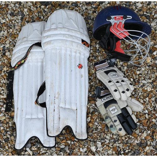 566 - A cricket bag and contents, including two bats, pads, gloves and helmet, to/w a set of practice stum... 