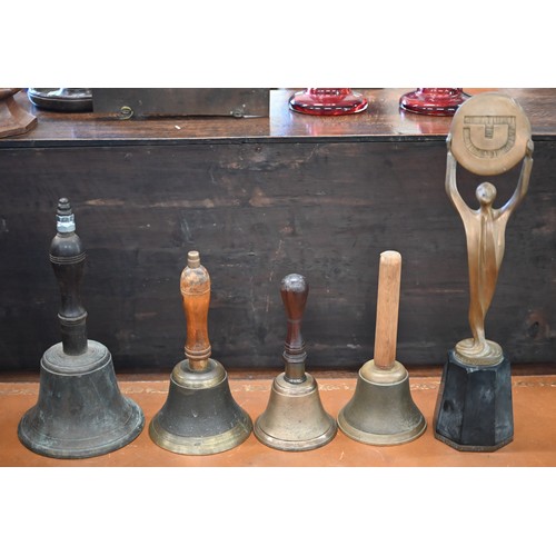 509 - Three antique metal mortars and four pestles, to/w four hand-bells and a Foster-Denovo figural troph... 