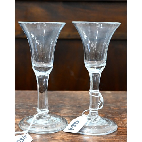 450 - A Georgian drinking glass with bell bowl, with bubble to base, plain stem and domed foot with folded... 