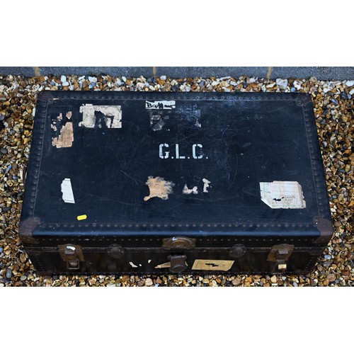 210 - A vintage navy blue steamer/school trunk stenciled ownership, initials 'G.L.C' and remnants of paper... 