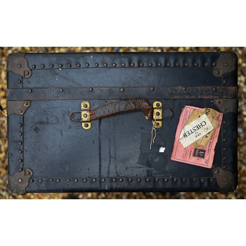 210 - A vintage navy blue steamer/school trunk stenciled ownership, initials 'G.L.C' and remnants of paper... 