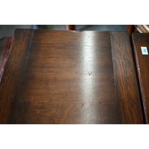 255 - An oak draw-leaf refectory dining table with cleated planked top on turned supports with stretchers,... 