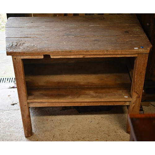 252 - A rustic pitch pine French side table with tapered left hand side and open fronted under-tier, 104 c... 