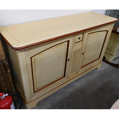 666 - A French cream painted sideboard by Le Creuset, the two panelled cupboard doors separated by fluted ... 