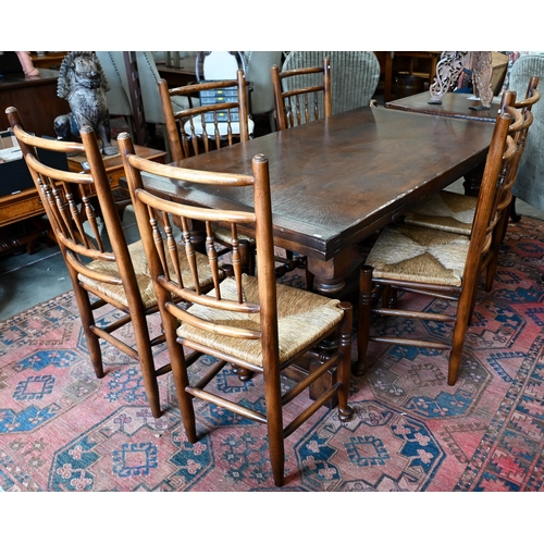 247 - An oak draw-leaf refectory dining table with cleated planked top on turned supports with stretchers,... 