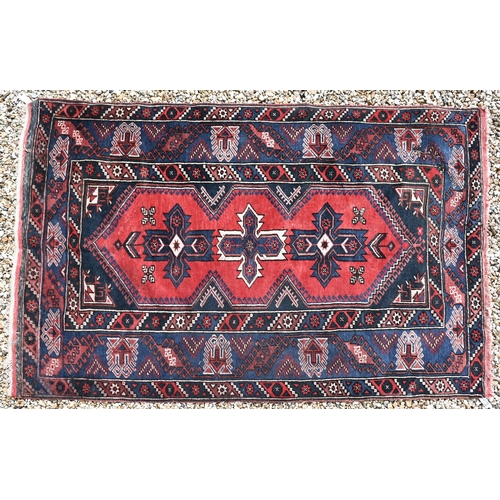 649 - A Turkish Dosemealti red ground rug of geometric design, blue multi borders, 208 x 130 cm