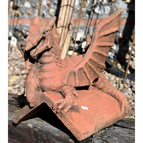 109 - A small cast terracotta recumbent dragon ridge tile, 35 cm h