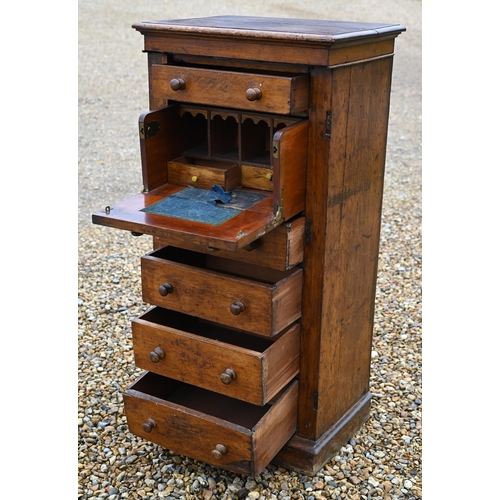 130 - A Victorian oak secretaire Wellington chest of drawers, with original turned fittings raised on a pl... 