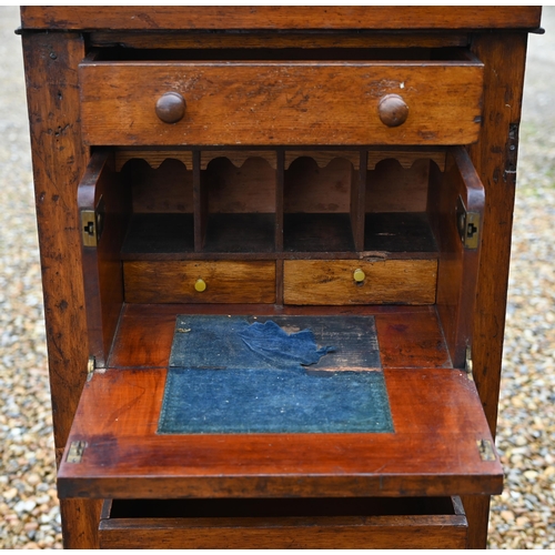 130 - A Victorian oak secretaire Wellington chest of drawers, with original turned fittings raised on a pl... 