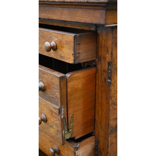 130 - A Victorian oak secretaire Wellington chest of drawers, with original turned fittings raised on a pl... 