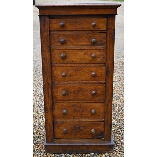 130 - A Victorian oak secretaire Wellington chest of drawers, with original turned fittings raised on a pl... 