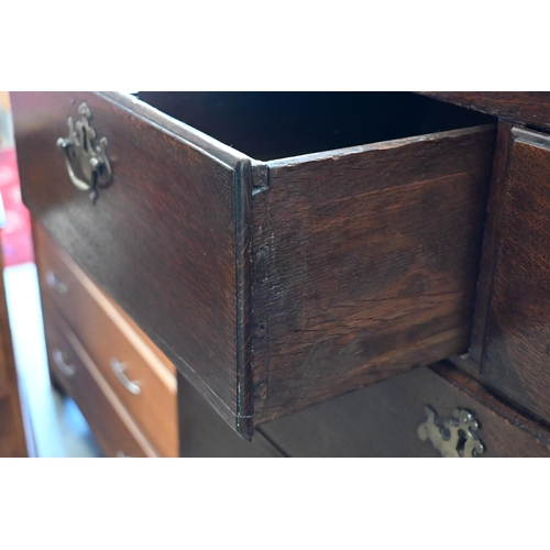 135 - A Georgian oak chest of two short over three long drawers on bracket feet, 98 x 53 x 104 cm high