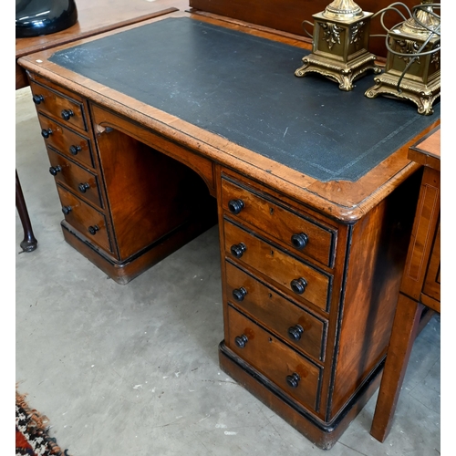 140 - A late Victorian Aesthetic movement oak eight drawer desk with turned ebony handles and inset leathe... 