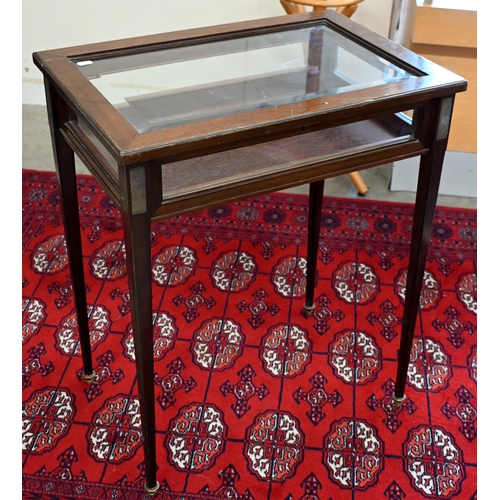 145 - A mahogany glazed vitrine on slender tapering supports, 60 x 40 x 74 cm high