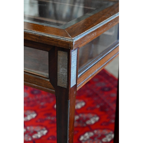 145 - A mahogany glazed vitrine on slender tapering supports, 60 x 40 x 74 cm high