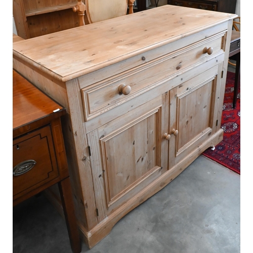 147 - A pine side cabinet/dresser base with single drawer over panelled cupboard doors, 124 x 54 x 94 cm h... 