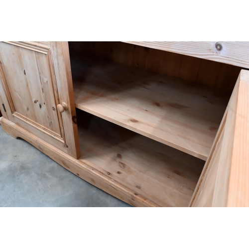 147 - A pine side cabinet/dresser base with single drawer over panelled cupboard doors, 124 x 54 x 94 cm h... 