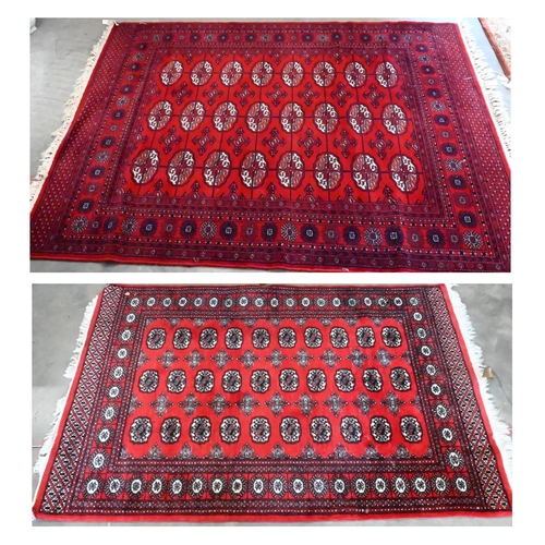 149 - A Turkoman design rug with repeat gul design on red ground 190 x 124 cm to/w similar machine made ex... 