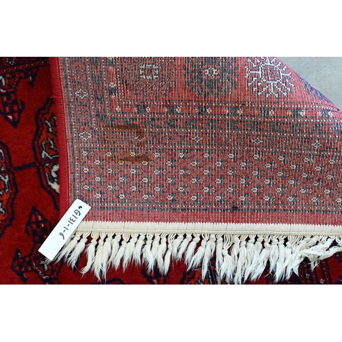 149 - A Turkoman design rug with repeat gul design on red ground 190 x 124 cm to/w similar machine made ex... 