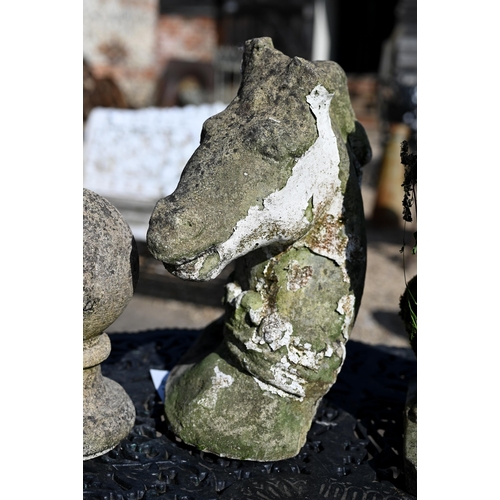 15 - A weathered cast stone seated lion, 44 cm h to/with a cast stone horse head, both a/f (2)... 