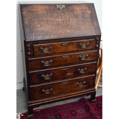 152 - #A small oak fall front bureau with four graduating drawers and shaped bracket feet, 70 cm wide x 44... 