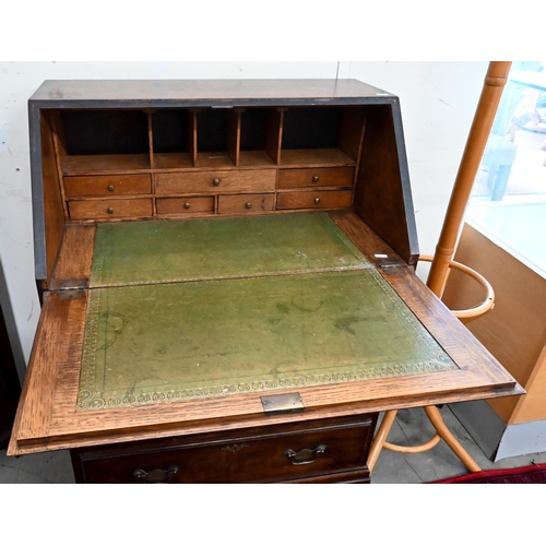 152 - #A small oak fall front bureau with four graduating drawers and shaped bracket feet, 70 cm wide x 44... 