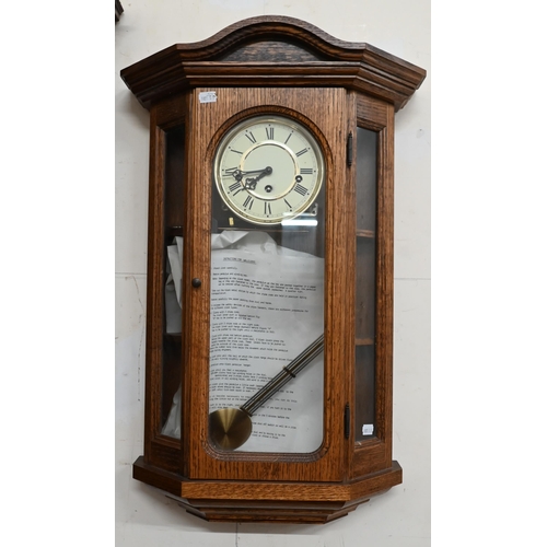 153 - A German glazed oak wall clock with triple train movement chiming on five-rod gongs c/w pendulum and... 