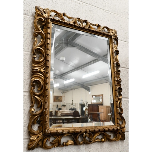 158 - A bevelled rectangular wall mirror in foliate giltwood and gesso frame