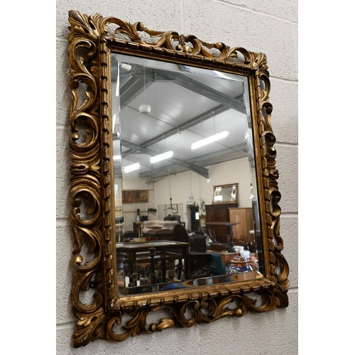 158 - A bevelled rectangular wall mirror in foliate giltwood and gesso frame