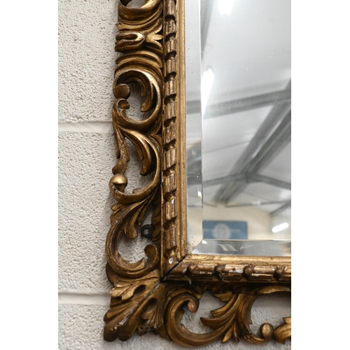 158 - A bevelled rectangular wall mirror in foliate giltwood and gesso frame