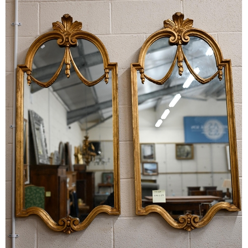 159 - A pair of large wall mirrors with decorative carved and moulded giltwood frames, 130 x 61 cm