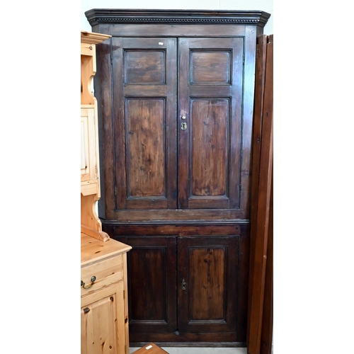 161 - #An antique stained pine corner cabinet with panelled doors and shelved painted interior, 202 cm hig... 