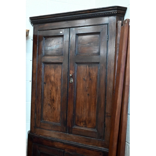 161 - #An antique stained pine corner cabinet with panelled doors and shelved painted interior, 202 cm hig... 