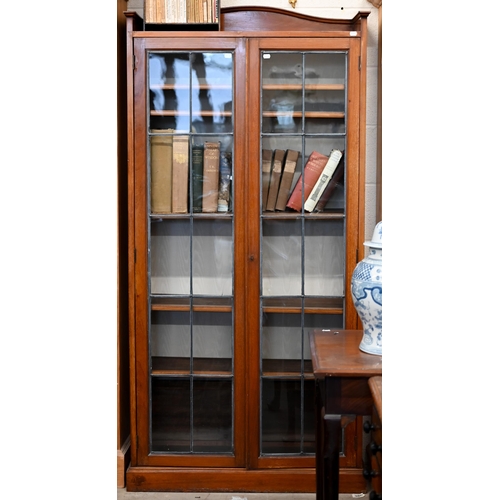 163 - A mahogany bookcase with leaded glazed doors enclosing adjustbale shelving, 188 x 28 x 180 cm high a... 