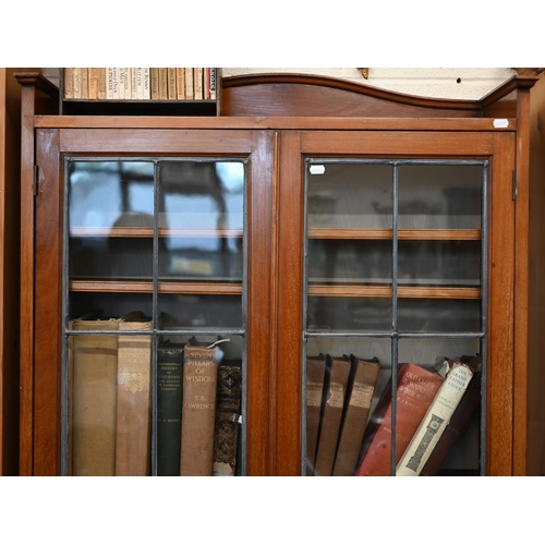 163 - A mahogany bookcase with leaded glazed doors enclosing adjustbale shelving, 188 x 28 x 180 cm high a... 