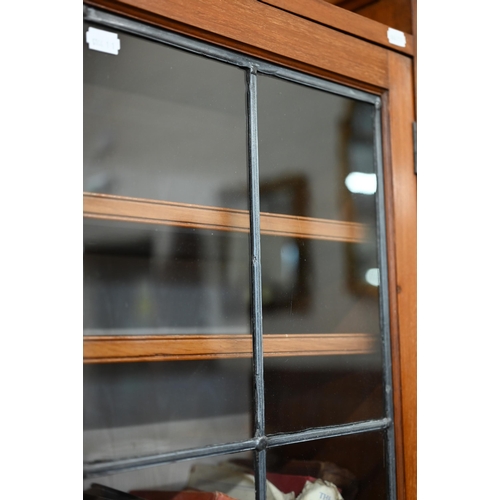 163 - A mahogany bookcase with leaded glazed doors enclosing adjustbale shelving, 188 x 28 x 180 cm high a... 